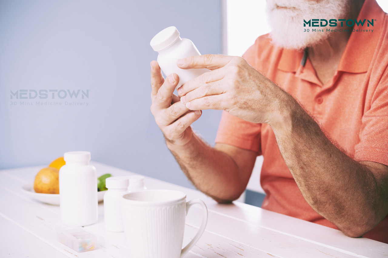 a man holding a white Painkillers bottle
