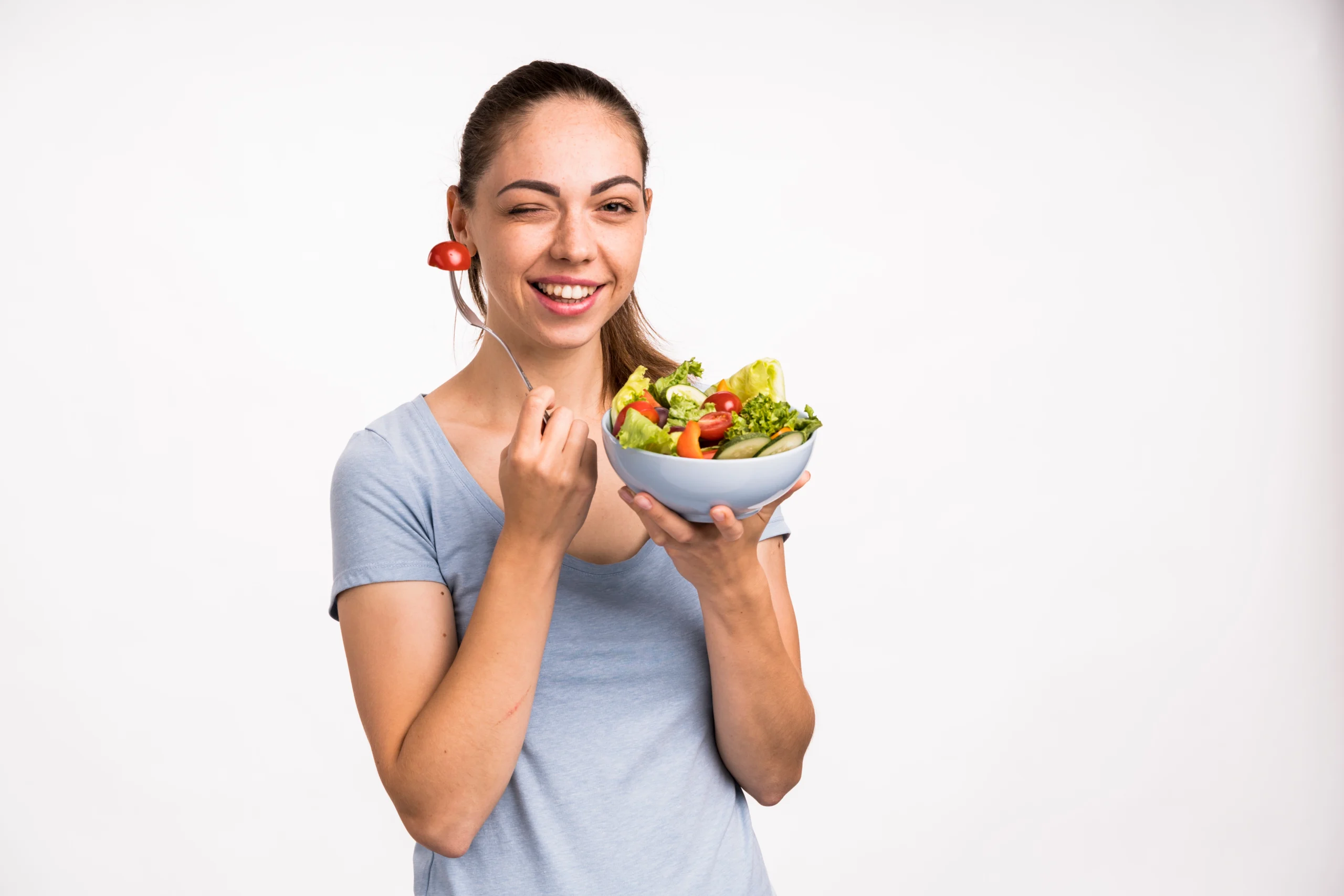 woman smiling holding salad scaled