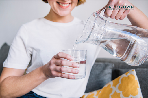 women water pouring in glass