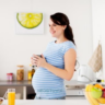 Pregnant woman holding a cup.