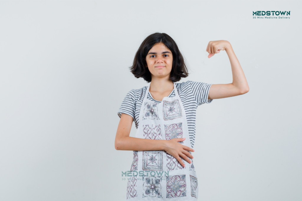 Person flexing arm in apron.